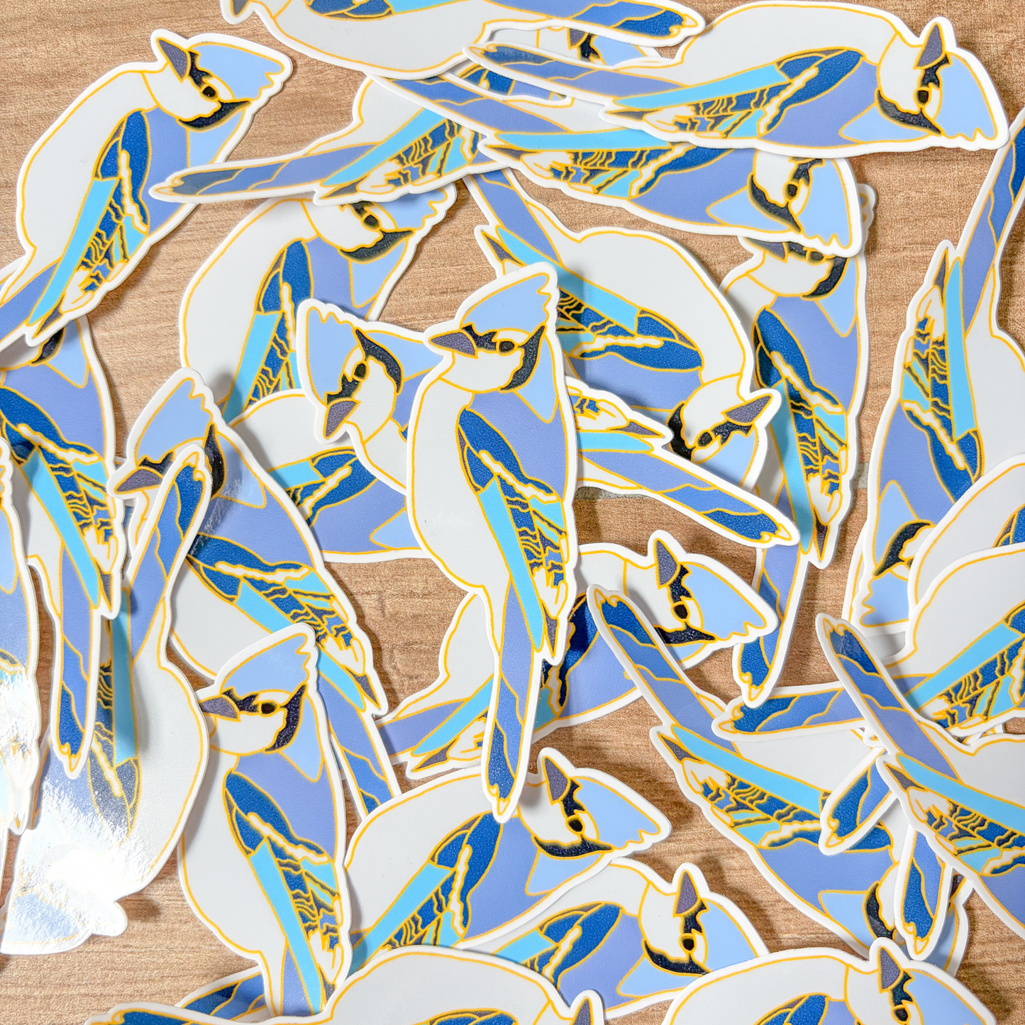 Collection of blue jay stickers on a wooden surface