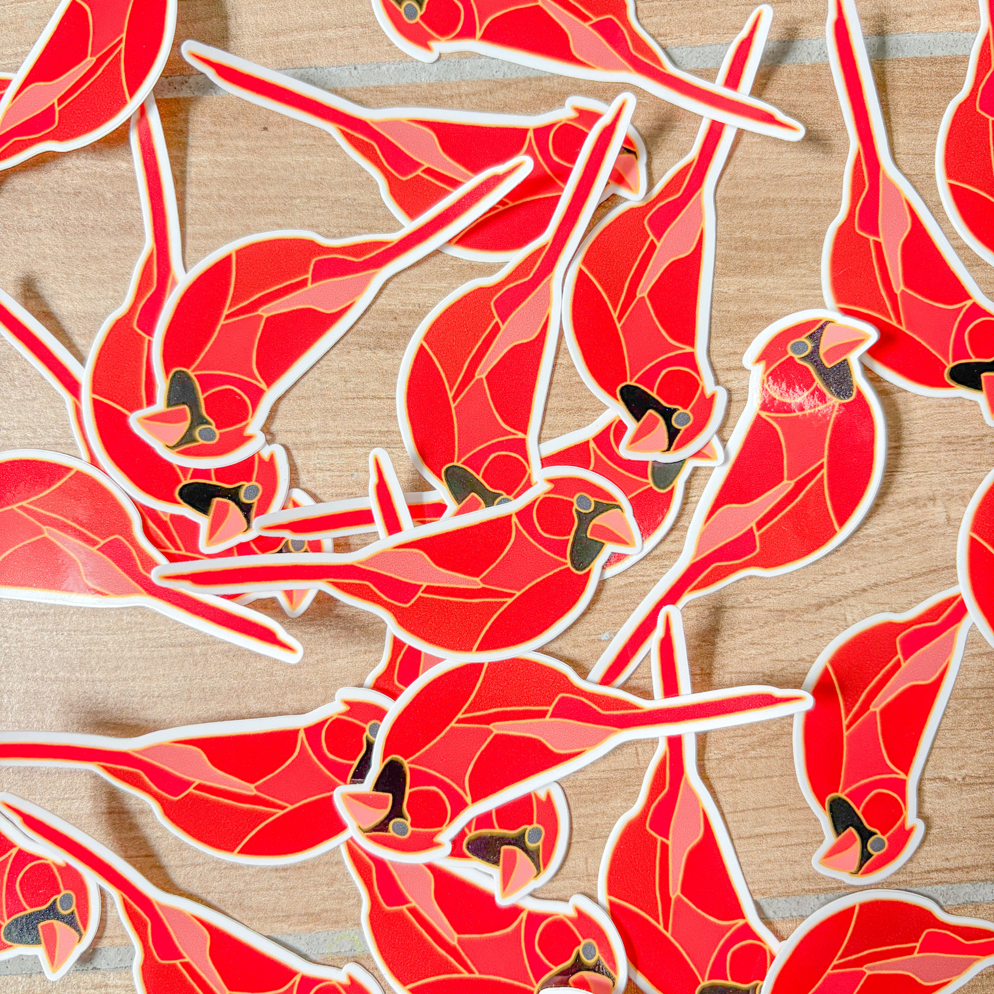 Red cardinal bird stickers on a wooden surface