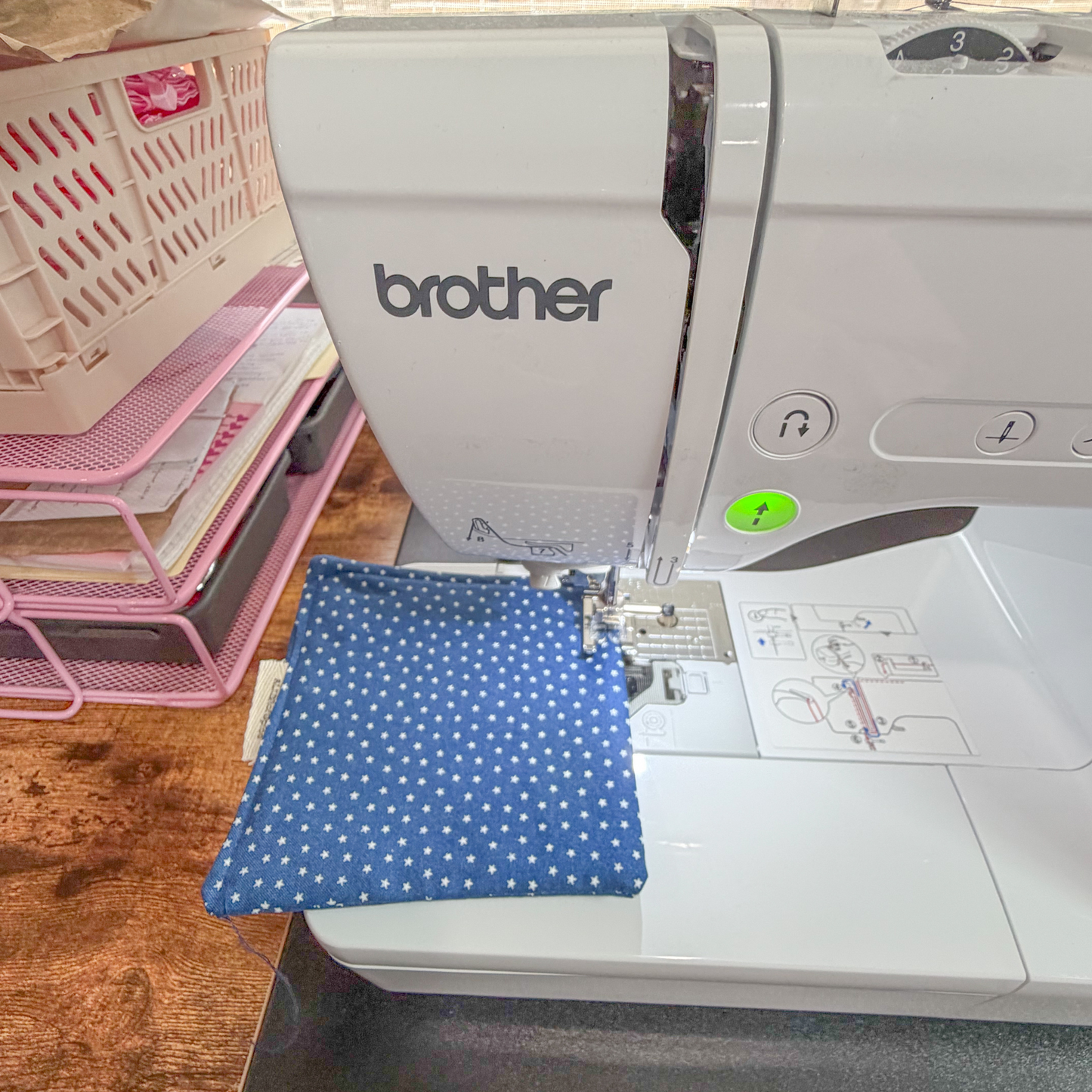 Brother sewing machine with blue fabric on a wooden table