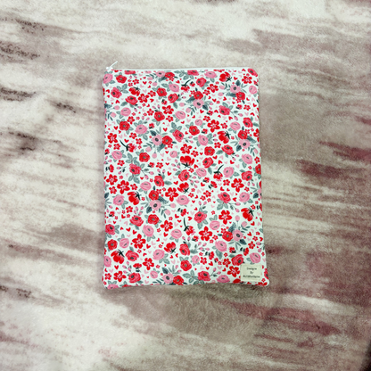 Floral-patterned book sleeve on a marbled surface