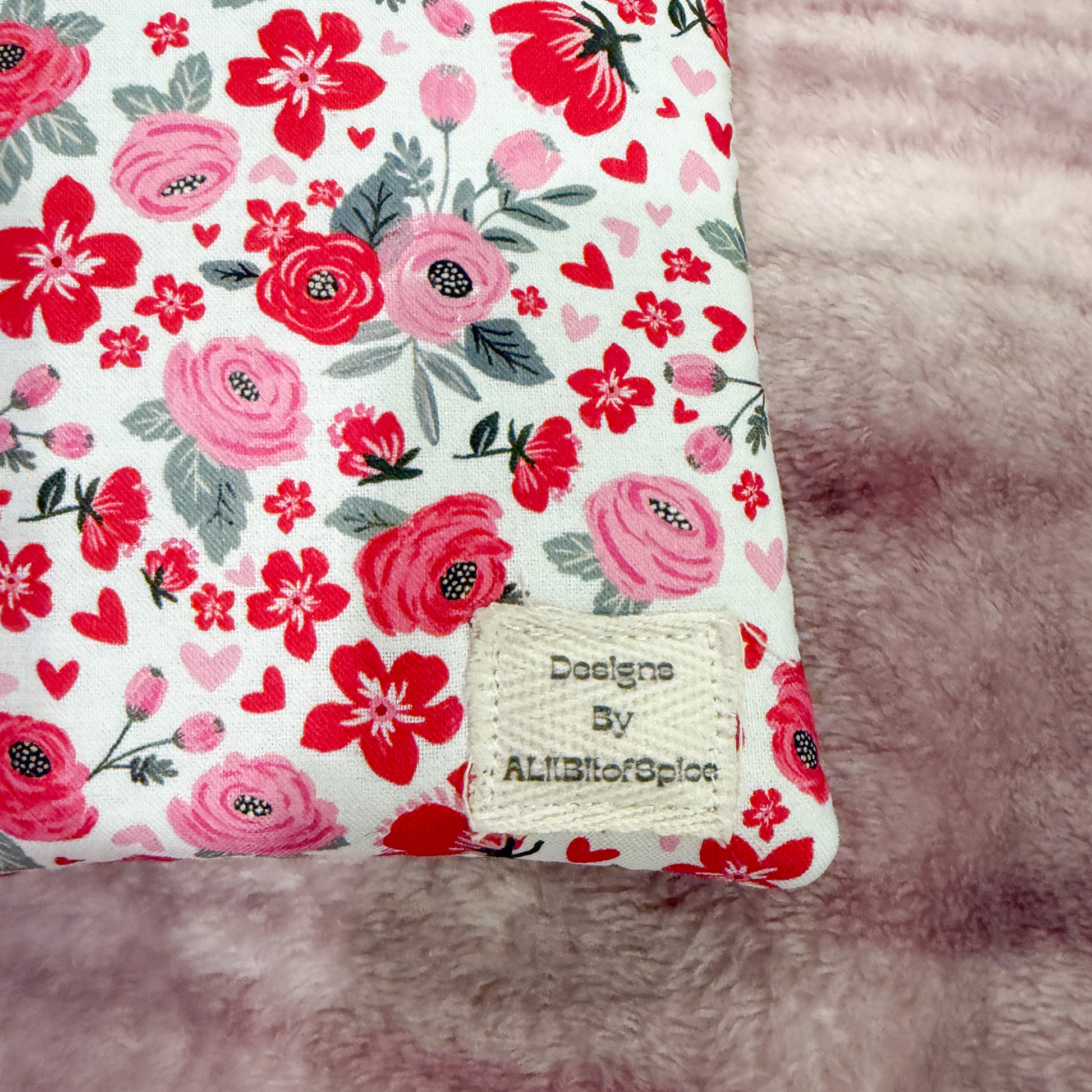 Floral patterned product with a label on a pink fluffy background