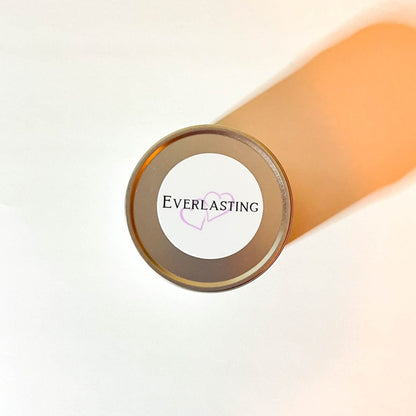 A silver tin labeled ‘Everlasting’ with 2 purple hearts on a white background